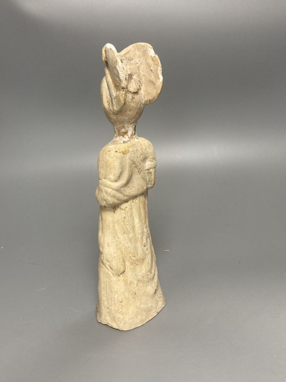 A group of Chinese Tang style pottery figures, tallest 28cm and a partially glazed ewer in sancai colours against a blue ground, 40cm